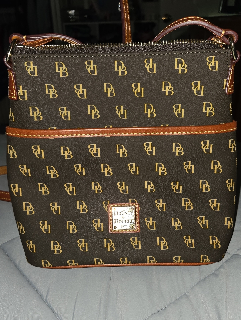 Dooney & Bourke Gretta bag features a distinctive navy monogram pattern w Brown